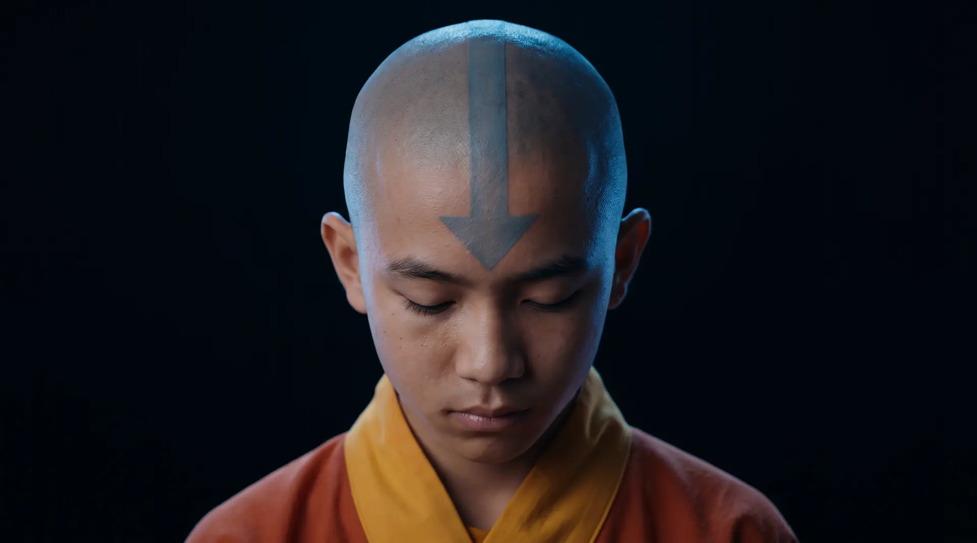 A young air monk with an arrow tattoo, head bowed in meditation